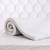 Rolled up mattress topper
